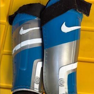 Nike Blue and Silver Shin Guards with Black Straps